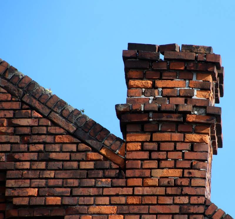 Damaged chimney on an Downey home showing cracks and missing mortar